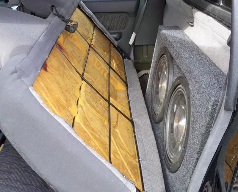 Installation example showing two subwoofers in an enclosure behind a folded-forward rear seat