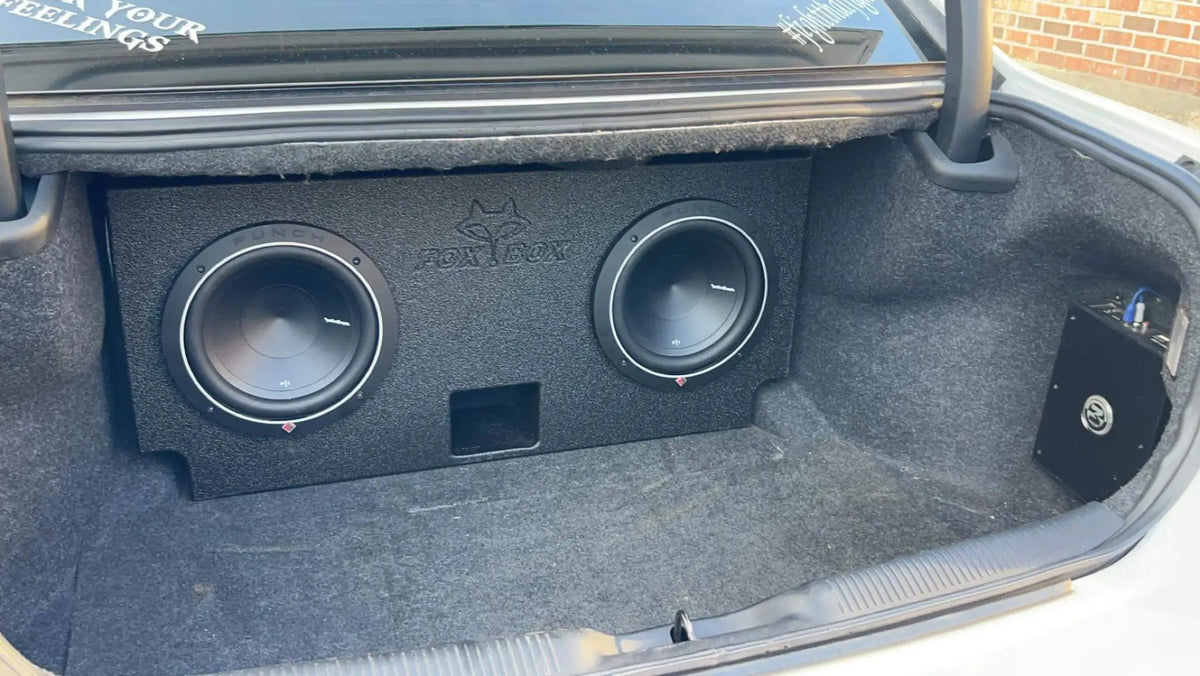 Dual-subwoofer enclosure installed in a car trunk
