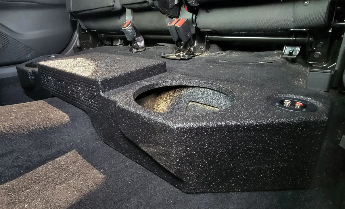 Fox Box Hyundai Santa Cruz enclosure fitted beneath the raised rear seat, showing a speaker opening and terminal cup