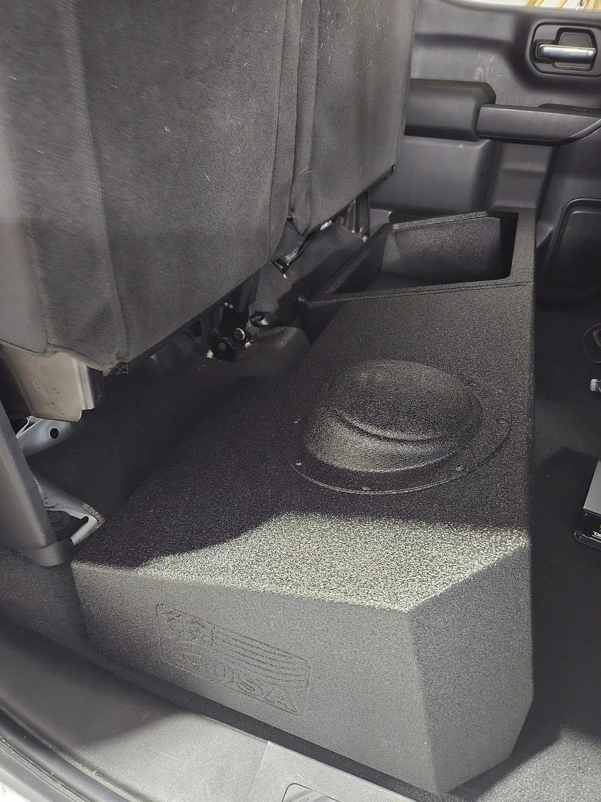 FOX BOX enclosure beneath a raised rear seat, showing the raised speaker section beside the storage area