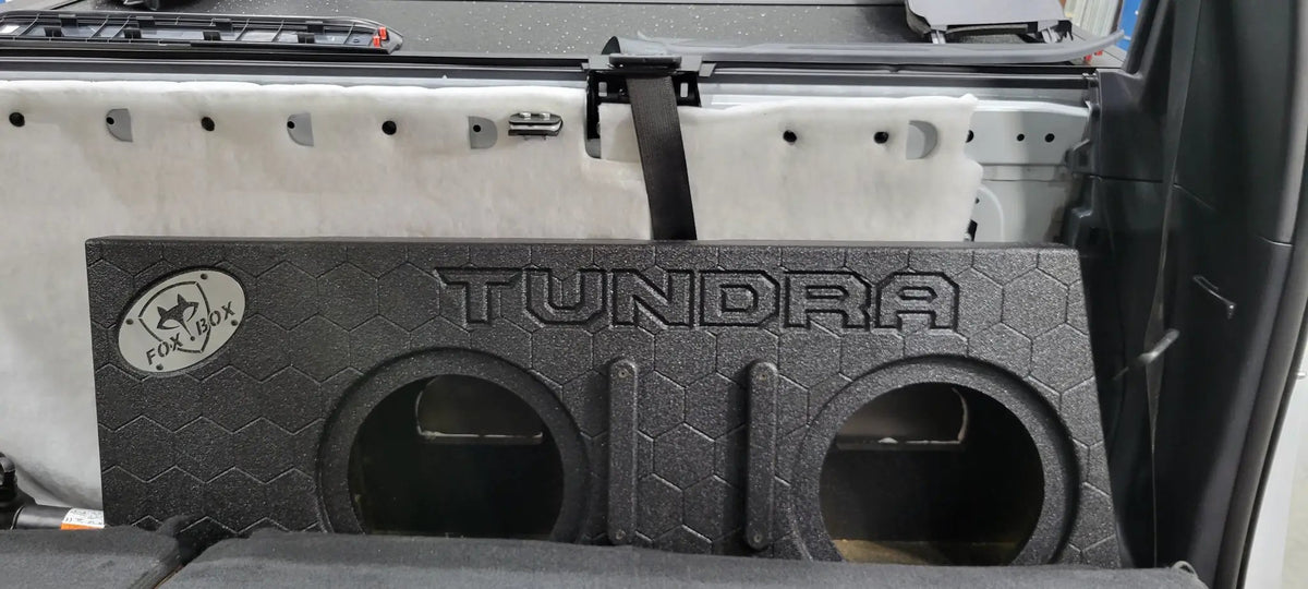 Front view of a Fox Box TUNDRA enclosure with two empty speaker openings inside the rear cabin