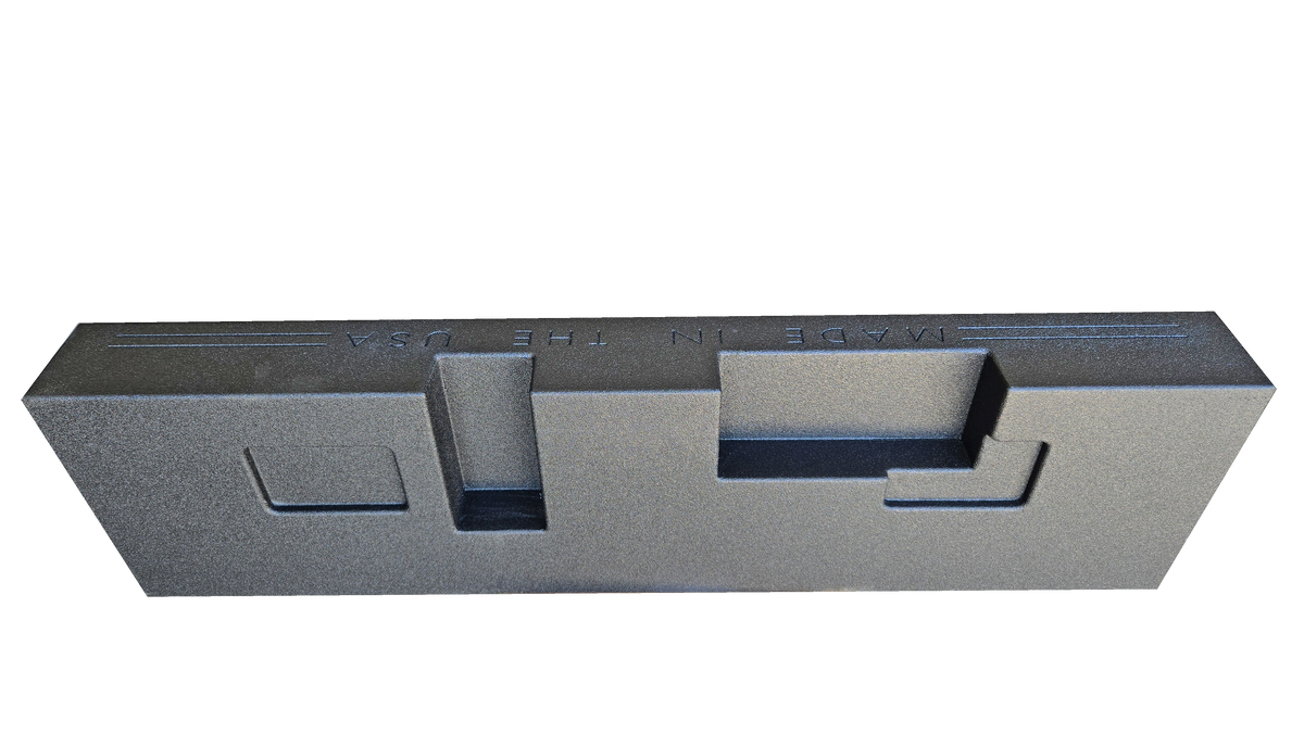 Rear view of a black subwoofer enclosure showing stepped recesses and a small rectangular panel