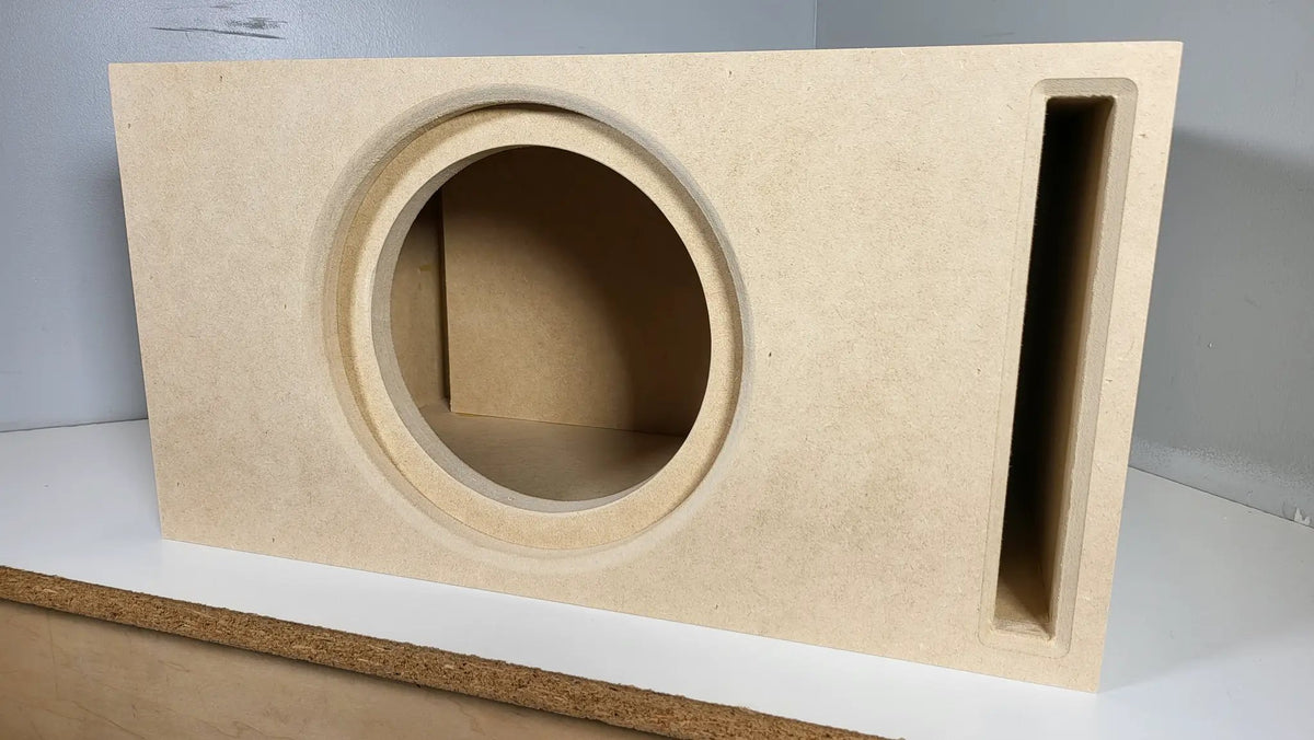 Close front view of a TRU SPEC enclosure showing its round cutout, recessed mounting lip and vertical slot port