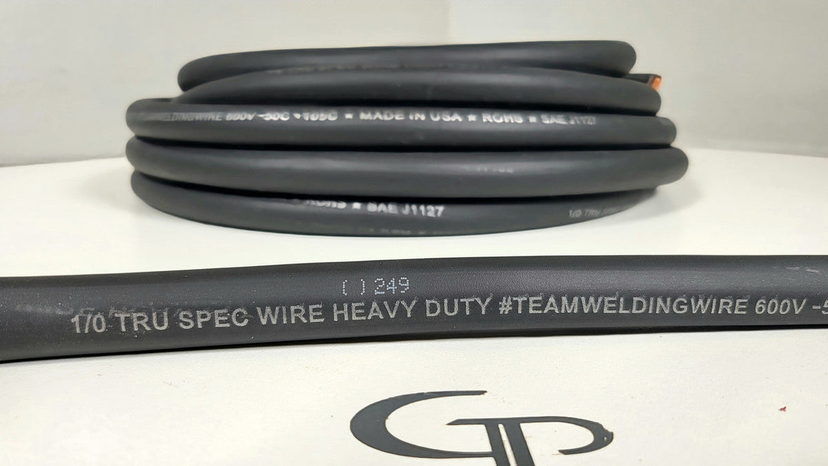 Close-up of the 1/0 TRU SPEC wire jacket markings in front of a coiled black cable