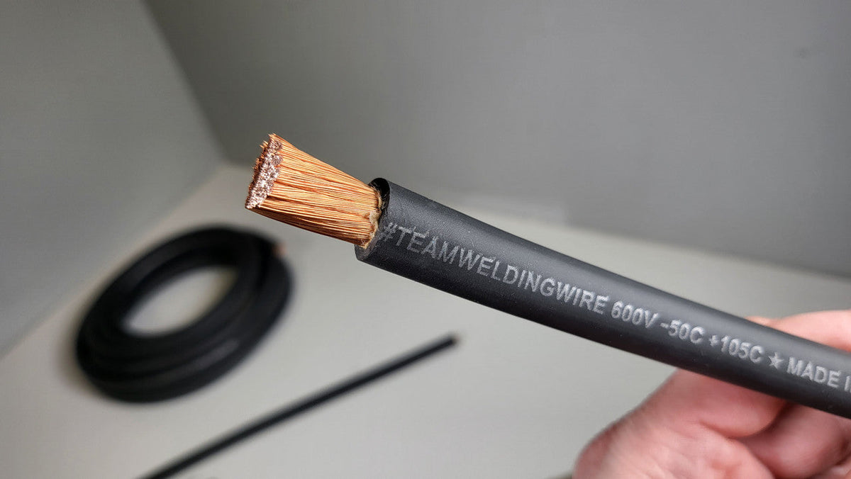 Hand holding black TRU SPEC cable with the stranded conductor exposed