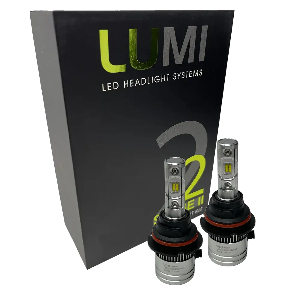 Two LUMI Stage 2 9004 LED Headlight Bulbs by Lumi are displayed in front of a black box labeled “LUMI LED Headlight Systems 2.†The bulbs have a metallic finish with prominent yellow CSP chips, delivering bright 6000K light for enhanced visibility.