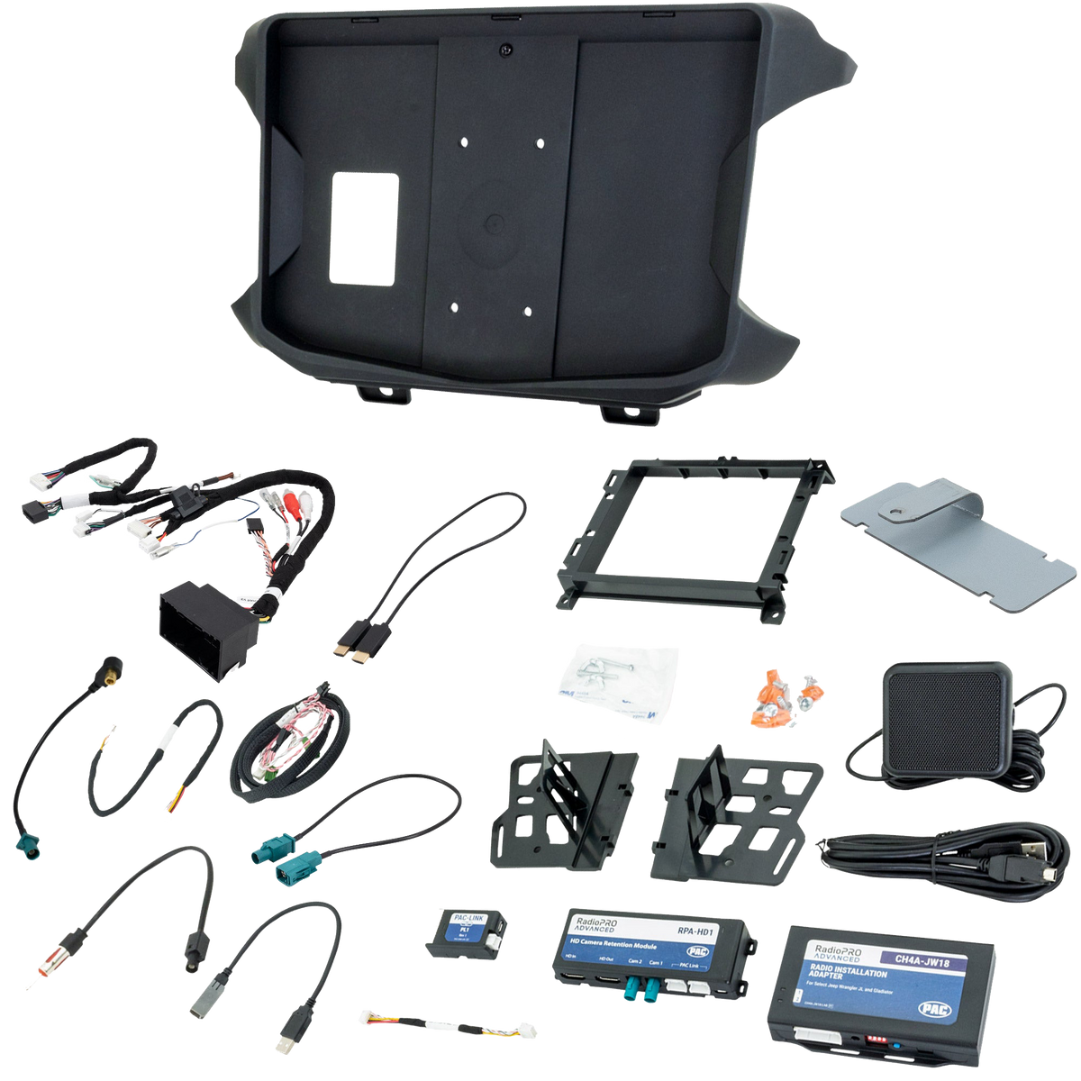 Radio installation kit laid out with molded dash panel, brackets, wiring harnesses, interfaces and mounting hardware