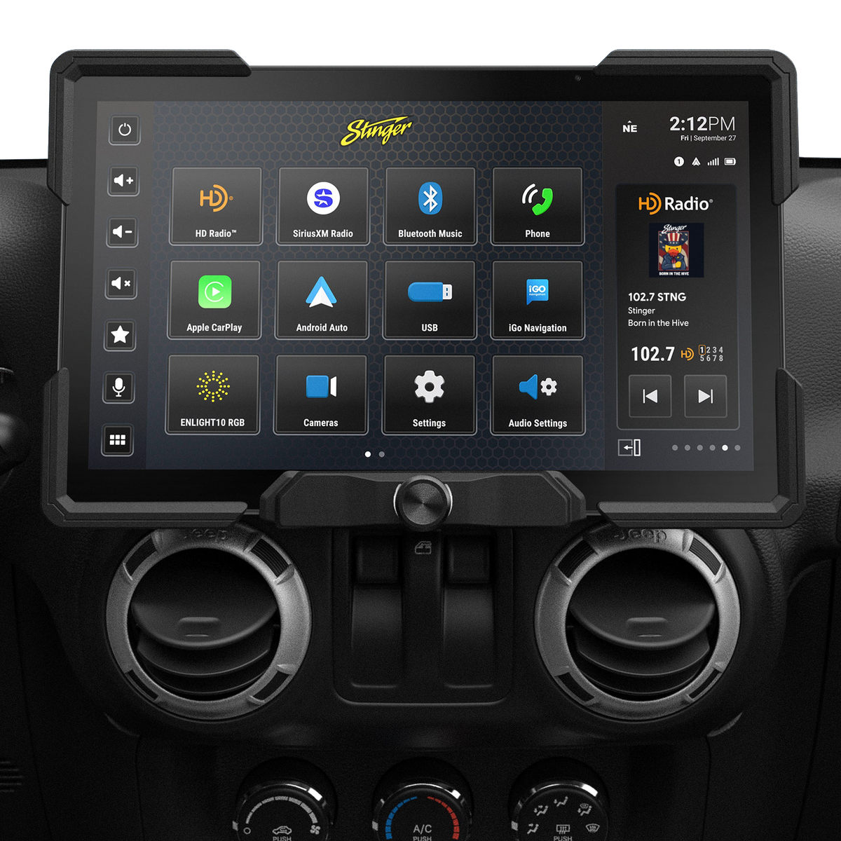 Wide Stinger touchscreen installed above round dashboard vents, showing source icons and a radio panel