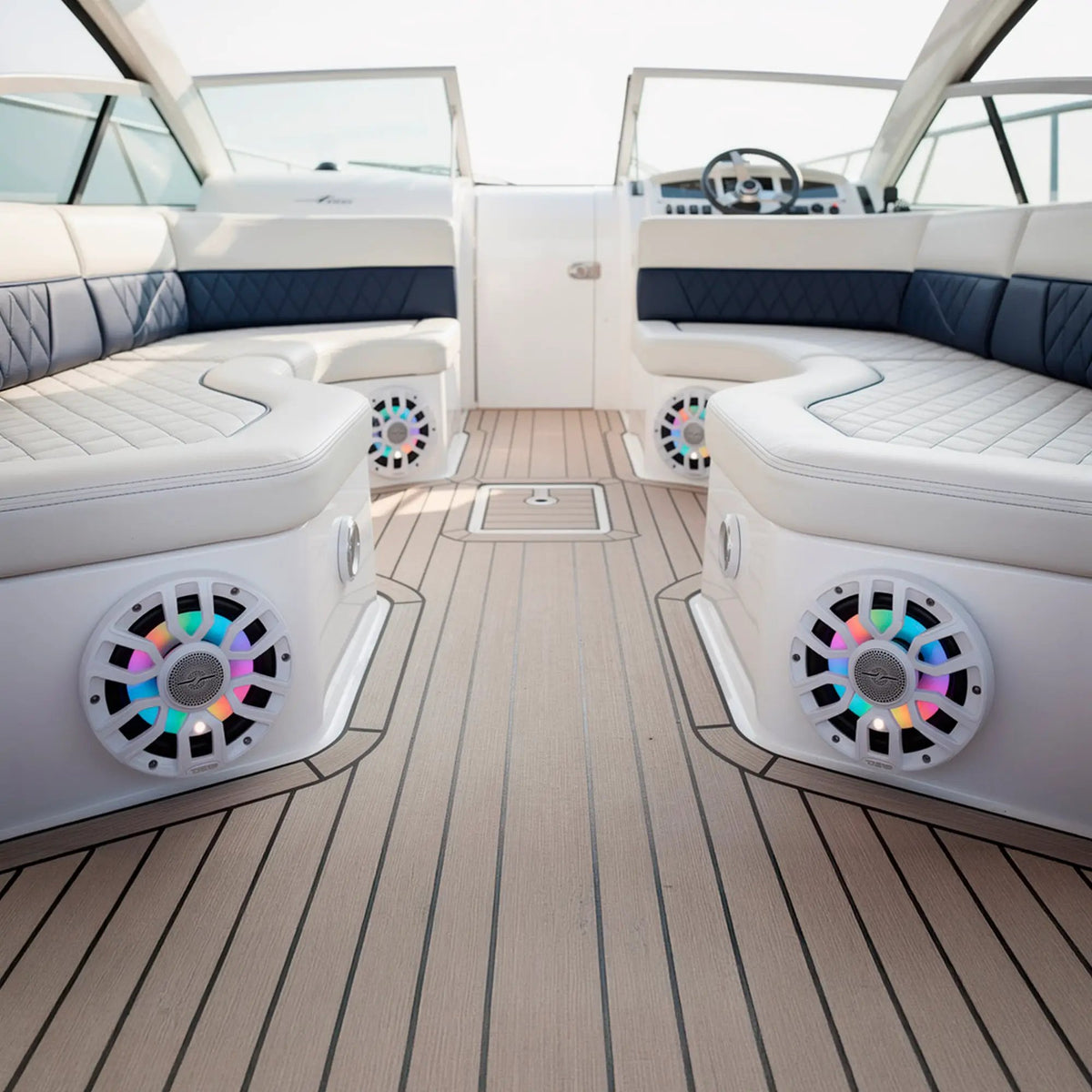 White speakers with multicolor lighting installed beneath the seats of a boat