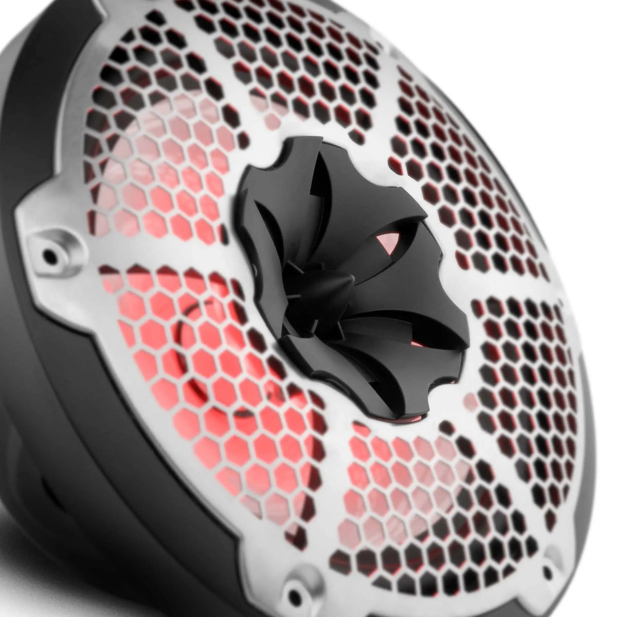 Close-up of a silver honeycomb speaker grille, black central tweeter and red illumination