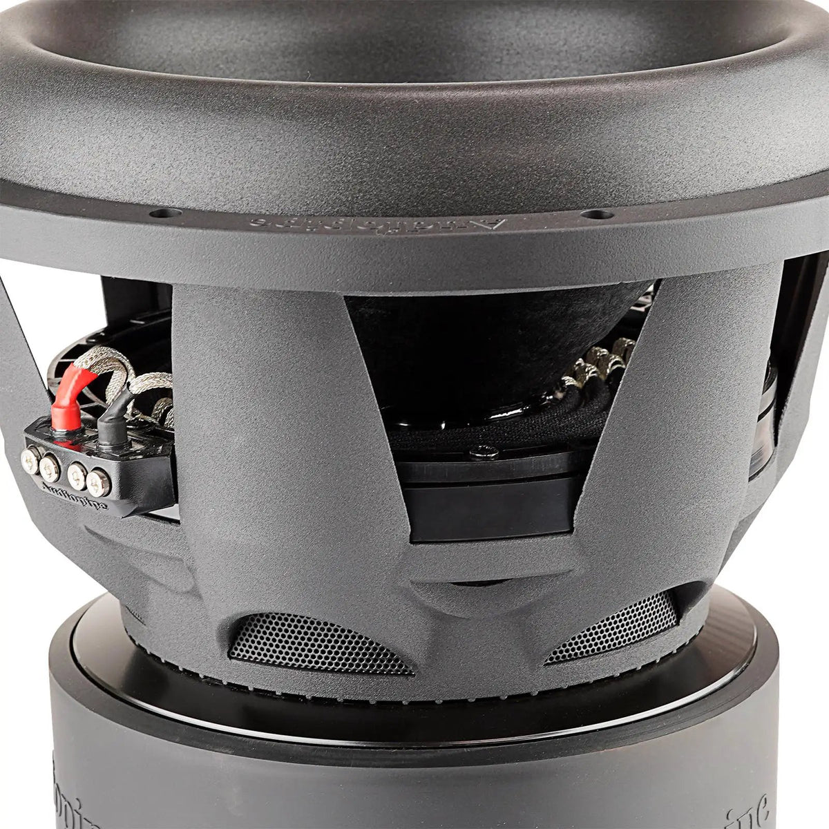Audiopipe subwoofer basket close-up showing ventilation openings, braided leads and the magnet assembly