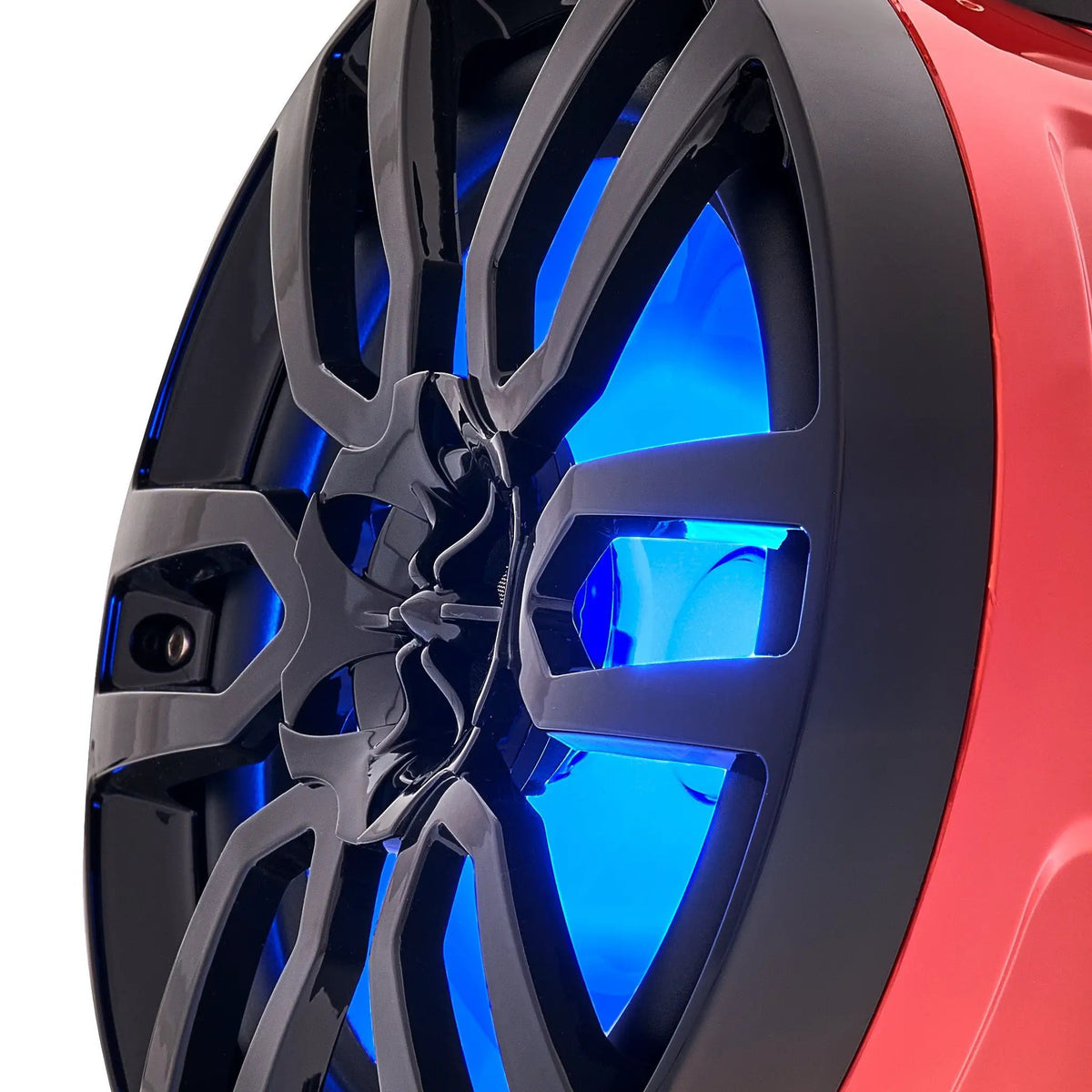 Close-up of a red speaker pod's black grille and central tweeter with blue illumination