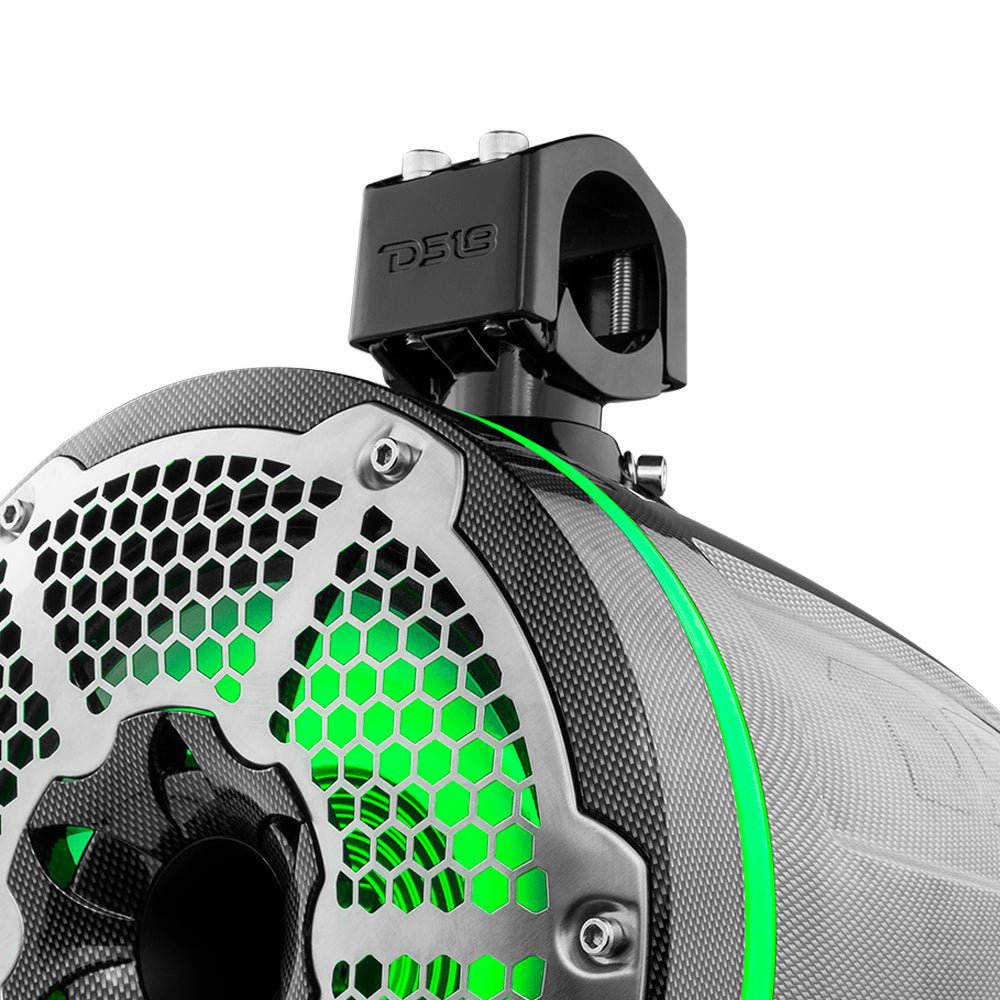 Close-up of a carbon-fiber-patterned tower speaker with green lighting, a silver honeycomb grille and mounting clamp