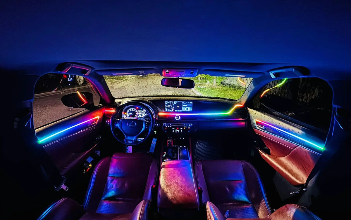 Car interior with multicolored accent lighting across the dashboard, doors and center console