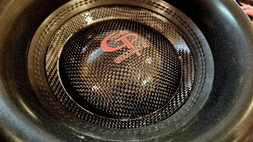 Close-up of the Team GP Undertaker subwoofer cone and woven-pattern dust cap with GP logo