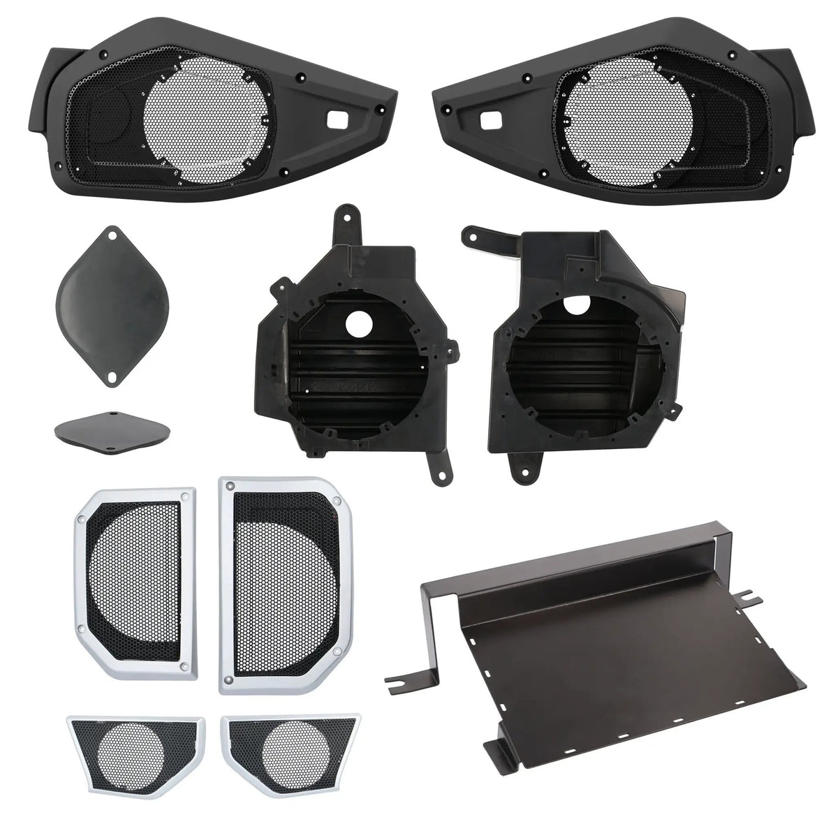 Speaker mounting housings and trim panels with replacement grilles and an amplifier mounting tray