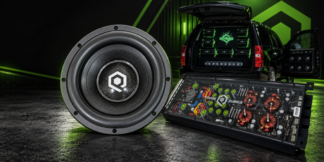 SoundQubed subwoofer and amplifier product flat lay on dark surface representing 12 Volt Outlet nationwide distributor spotlight for SoundQubed car audio