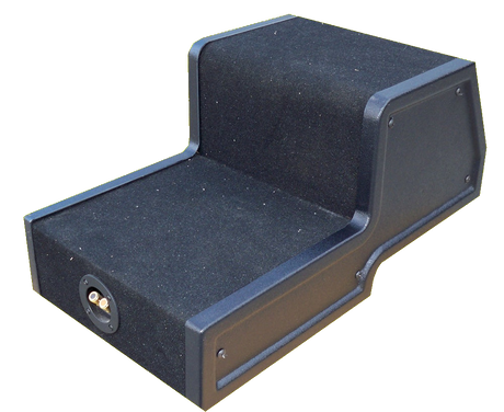 Rear view of a stepped black enclosure showing a flat access panel and terminal cup