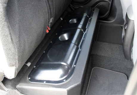 FOX BOX enclosure installed beneath a raised rear bench seat, showing its glossy molded section