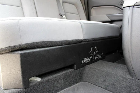FOX BOX enclosure beneath a lowered rear bench seat, with the logo visible along its front edge