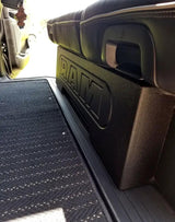Side view of a RAM-branded enclosure fitted under a rear seat beside the door sill
