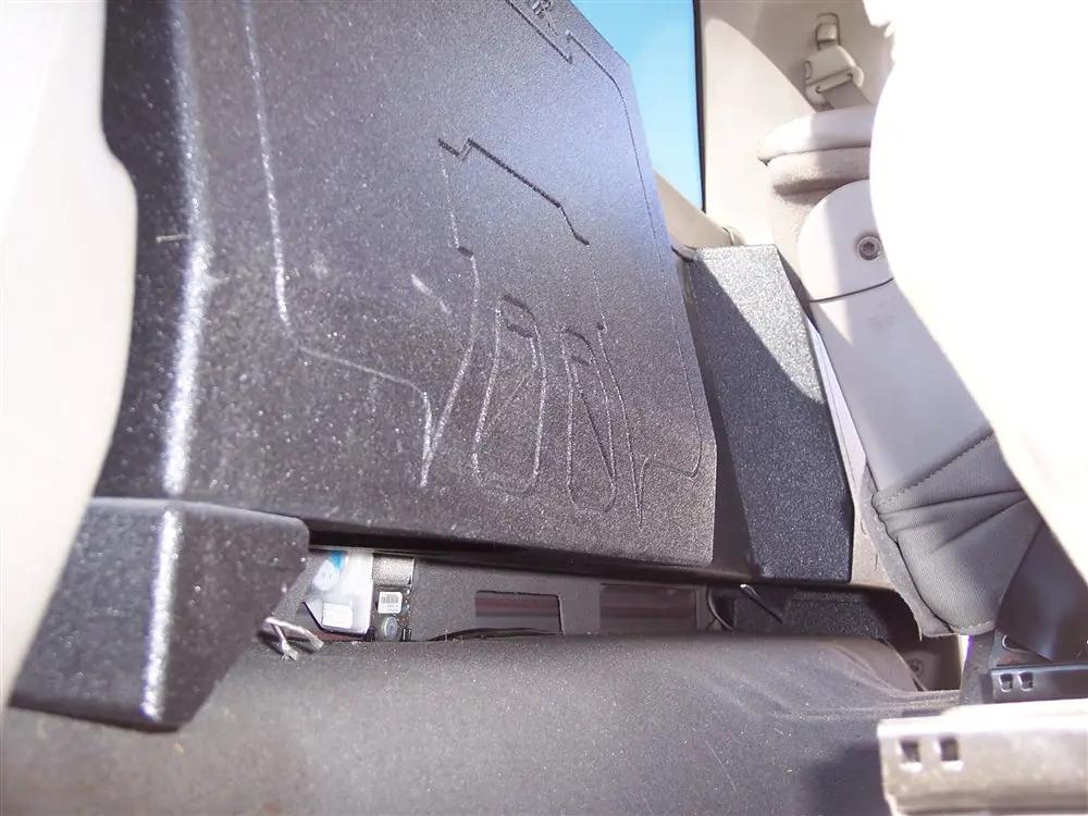 Fox Box Dodge Ram regular-cab enclosure installed behind the seat, showing the adjacent amplifier-rack area