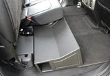 Side view of an installed subwoofer enclosure showing its rectangular end port
