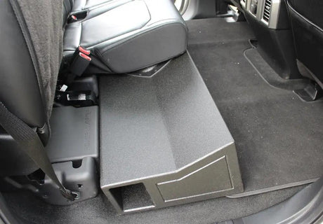 Side view of an installed subwoofer enclosure showing its rectangular end port