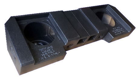 Black subwoofer enclosure with two speaker openings and central vent channels, angled view