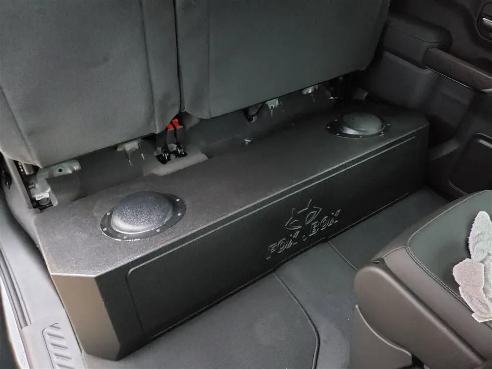 Fox Box GM enclosure installed under the raised rear seat, with its molded rear surface facing upward