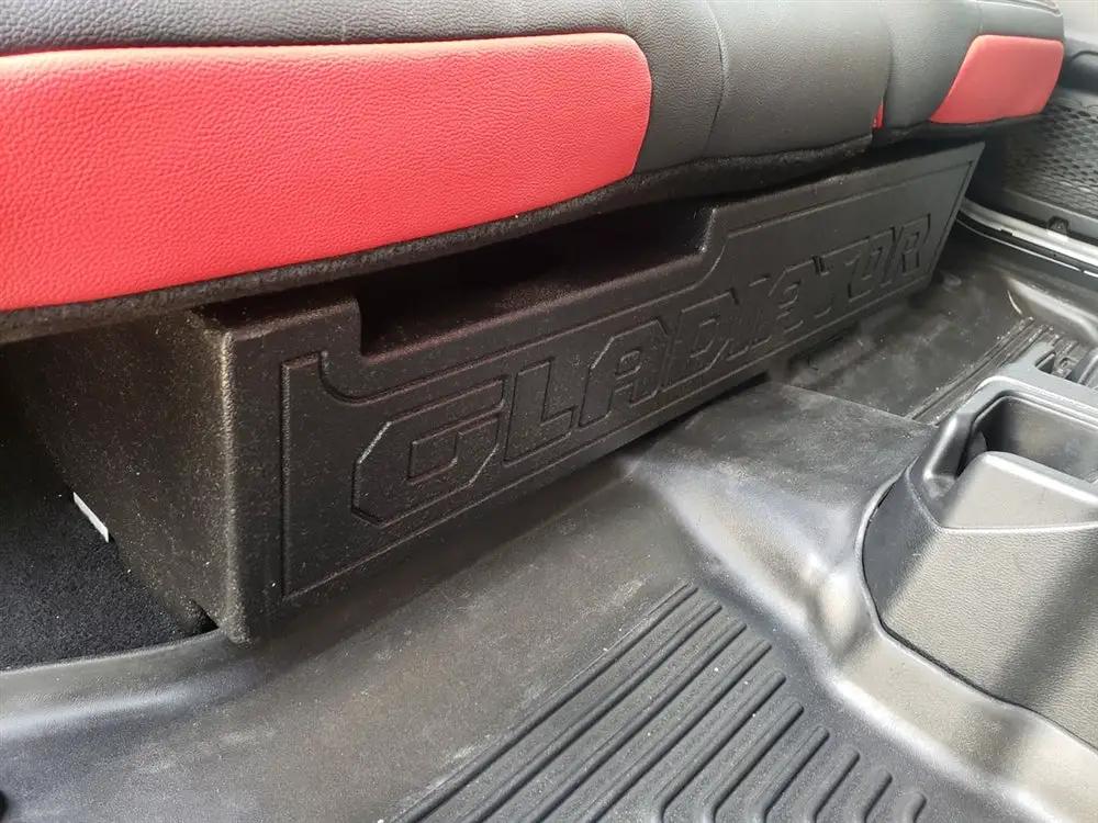 Fox Box Gladiator enclosure beneath the lowered rear bench, showing GLADIATOR lettering across its front