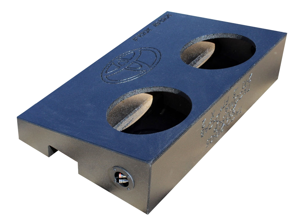 Angled underside of a Fox Box enclosure with two speaker openings, a Toyota emblem and a terminal cup