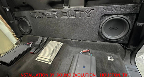 Installation example showing a SUPER DUTY Fox Box enclosure with two subwoofers behind the rear seating area
