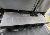 Four-opening subwoofer enclosure with RAM lettering shown beneath a raised rear seat