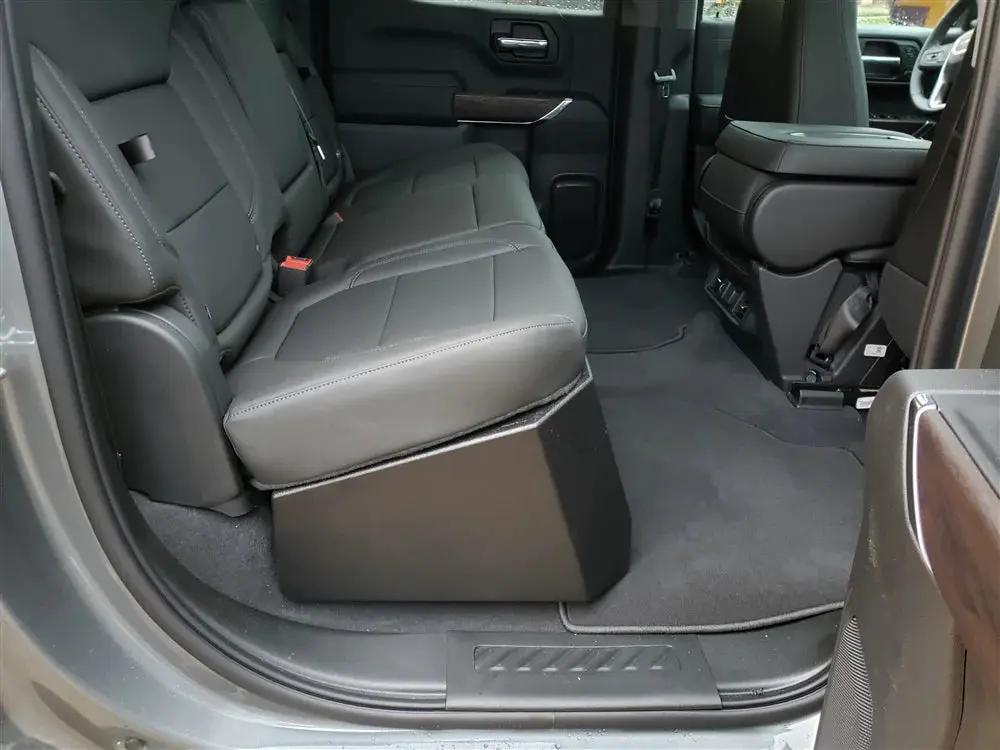 Side view of a black enclosure installed beneath a rear bench seat