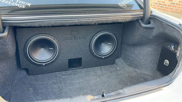 Dual-subwoofer enclosure installed in a car trunk