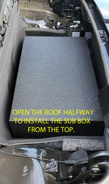 Installation photo instructing that the convertible roof be opened halfway to insert the subwoofer enclosure from above