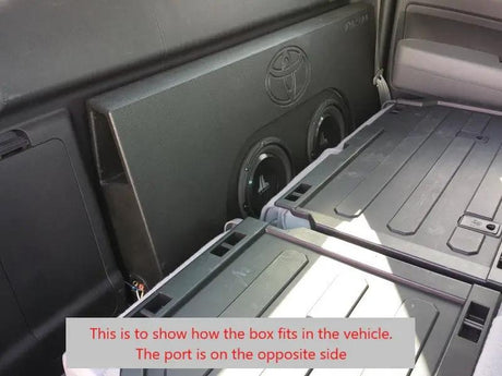 Installation reference showing a subwoofer enclosure behind folded rear seats, with a note that the port is on the opposite side