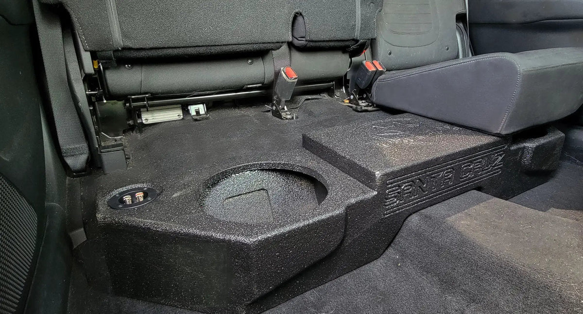 Fox Box enclosure with SANTA CRUZ lettering beneath a raised rear seat, with an empty speaker opening visible