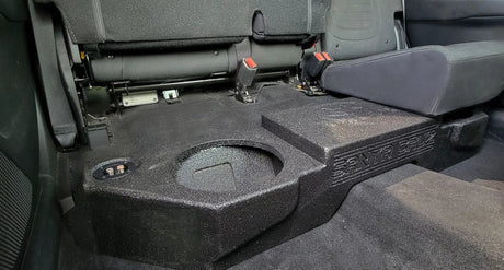 Fox Box enclosure with SANTA CRUZ lettering beneath a raised rear seat, with an empty speaker opening visible