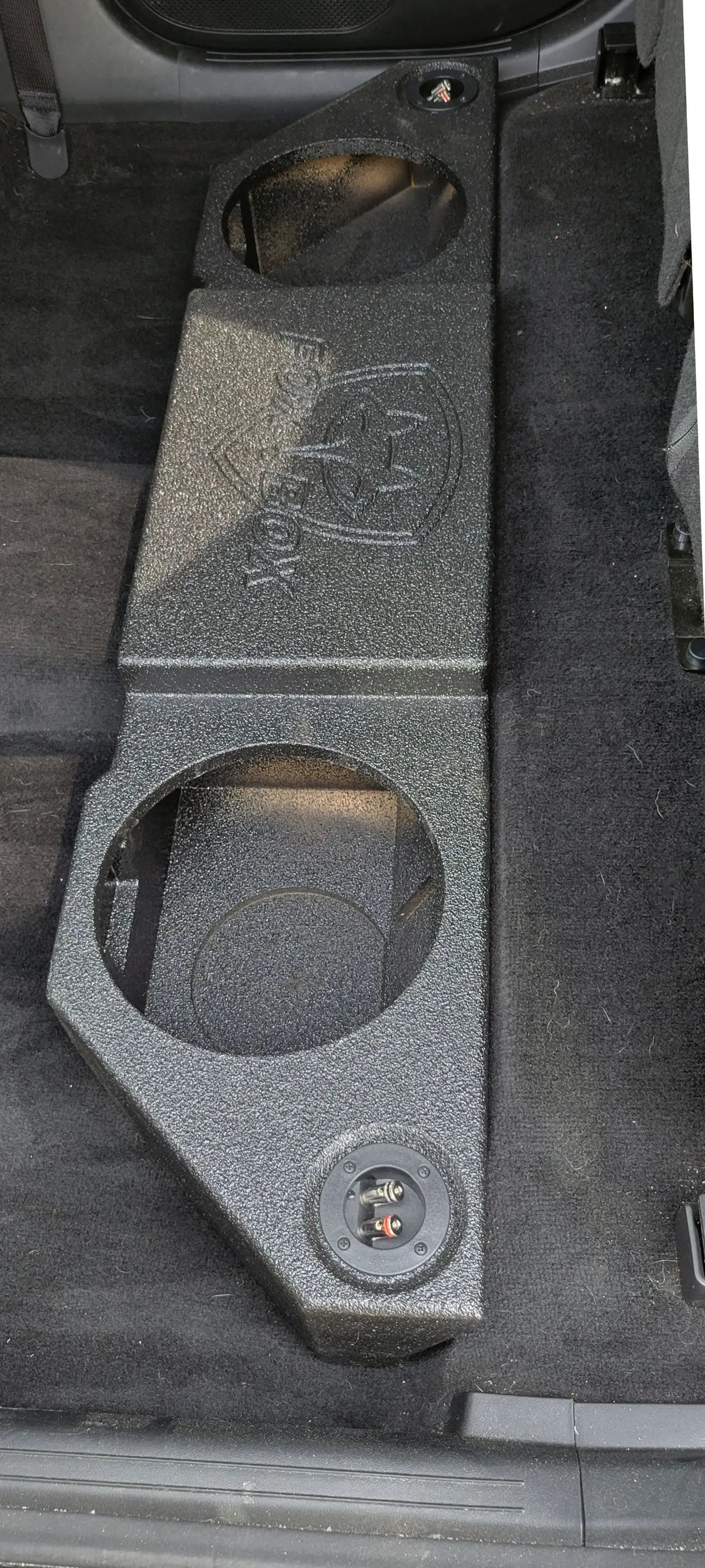 Overhead view of a Fox Box enclosure with two empty speaker openings fitted on the rear cabin floor