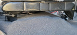Close-up of a seat frame raised above the carpet on black spacer blocks