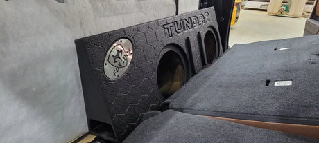 Fox Box TUNDRA enclosure with two empty speaker openings positioned behind folded-forward rear seats