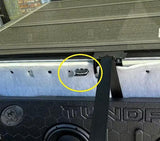 Yellow circle highlights the rear-seat latch above a TUNDRA-branded subwoofer enclosure