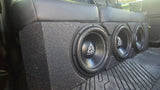 Installation example showing three Trinity subwoofers in an enclosure beneath a rear bench seat