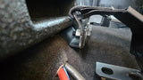 Close-up of the Fox Box Ford Super Duty enclosure mounting bracket and adjacent seat-belt hardware