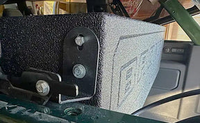 Close-up of a Fox Box Ford Bronco enclosure mounting bracket, bolts and attached strap