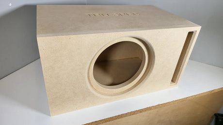 TRU SPEC enclosure on a workbench, angled view of its round front cutout and vertical slot port