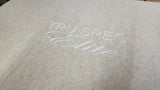 Close-up of the TRU SPEC Elite logo engraved into an unfinished wood enclosure panel