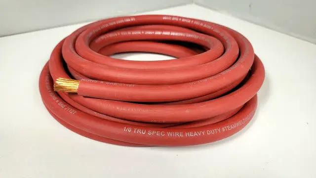 Coiled red TRU SPEC power wire with exposed copper strands at its cut end